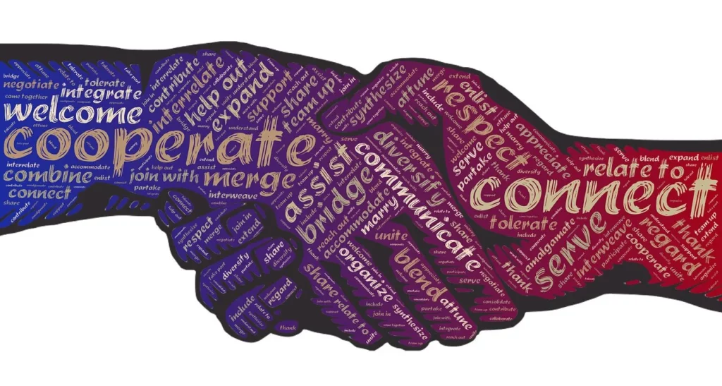 Das Bild zeigt eine farbige grafische Darstellung eines Händedrucks. Auf den Händen sind Wörter wie "Verbunden", "Hilfe", "Brücke" und ähnliche Ausdrücke eingefügt, die die Verbundenheit der Menschen miteinander zum Ausdruck bringen.